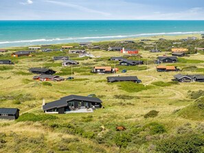 A coastal residential area with houses and a view of the ocean.