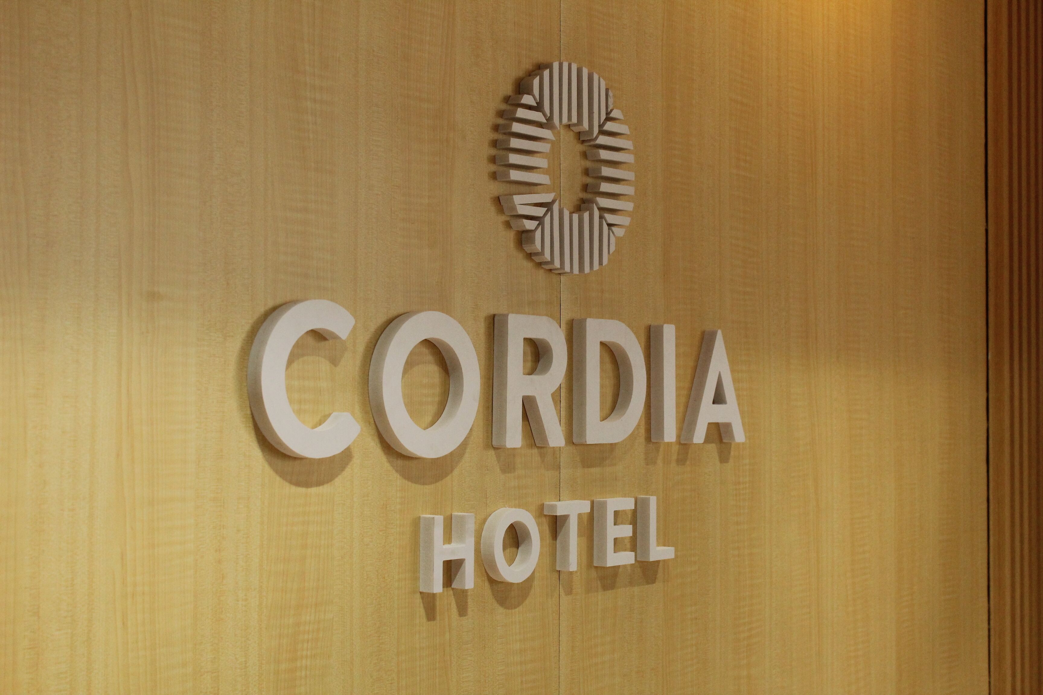 A sign for Cordia Hotel with a circular logo above the name.