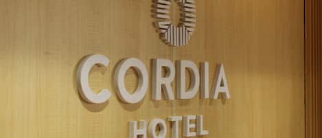 A sign for Cordia Hotel with a circular logo above the name.