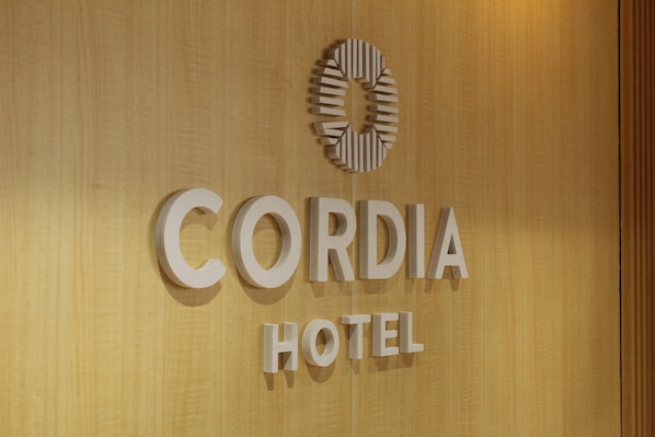 A sign for Cordia Hotel with a circular logo above the name.
