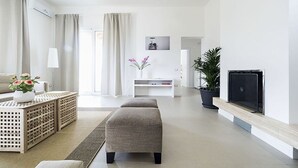 A modern living room with a sofa, a coffee table, a TV, and a potted plant. - Beautiful private villa for 6 people with WIFI, private pool, A/C, TV and terrace (Marsala)