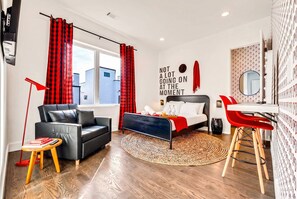 A modern bedroom with a bed, a desk, a chair, a sofa, and a window. - Fall getaway: two rooftop hot tub homes with theater & bar, sleeps 24, Nashville (Nashville)