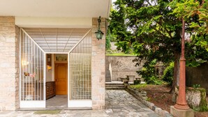 A traditional Japanese-style entrance with a wooden door and sliding glass panels.