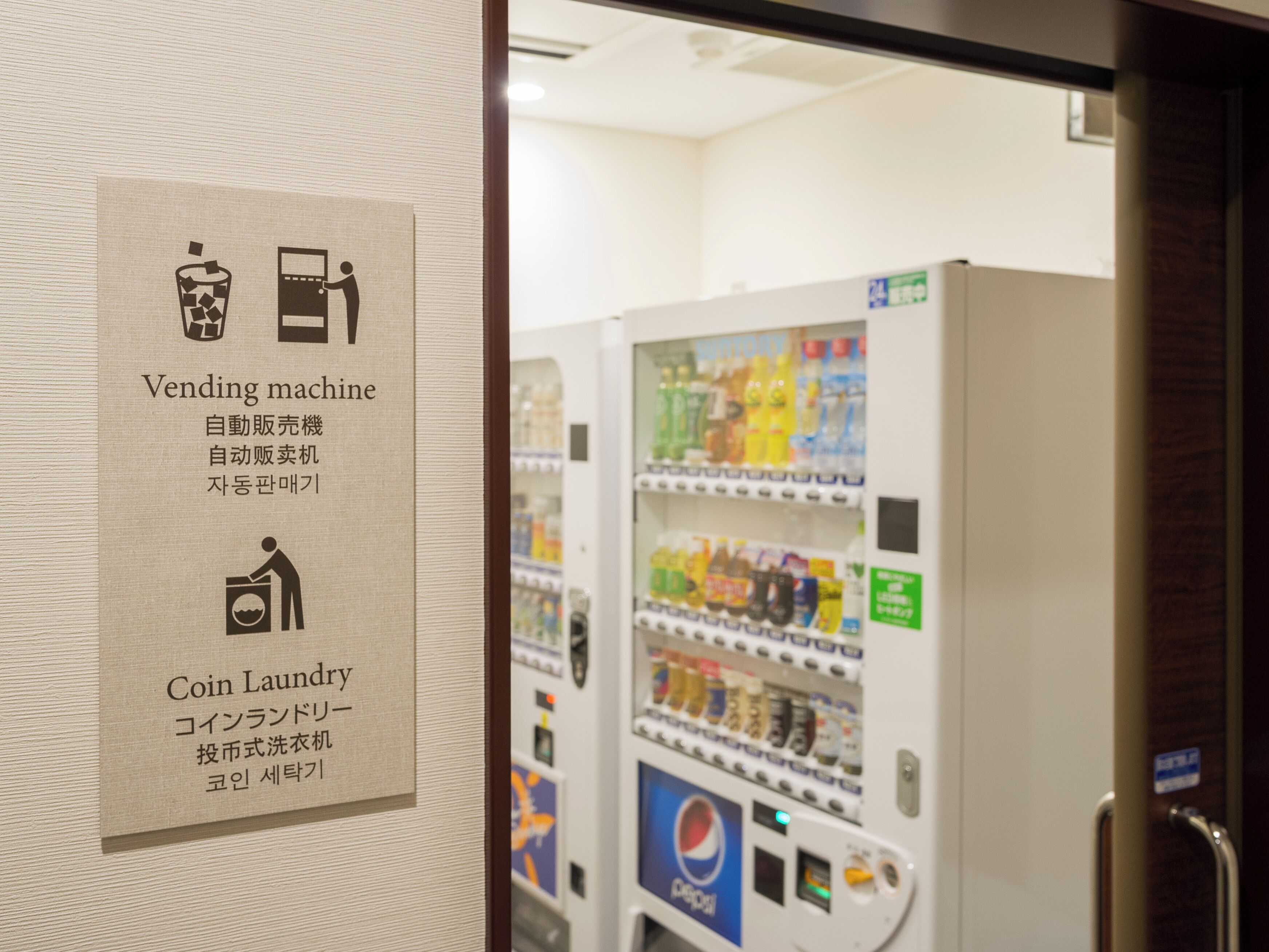 A vending machine with a coin laundry sign.