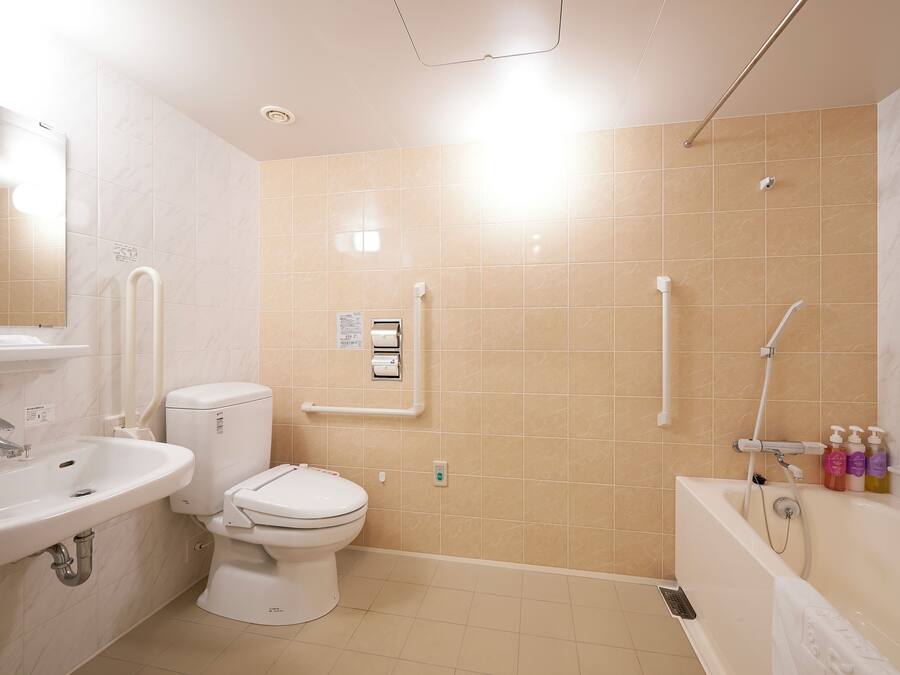 A bathroom with a sink, toilet, and bathtub.