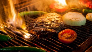 A steak being grilled with vegetables on a grill. - Charleville Cattle Camp Hotel  (Charleville)