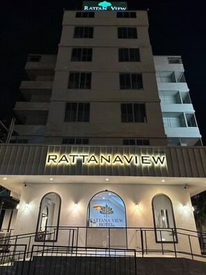 A hotel named Rattanview with a modern facade, illuminated signage, and a prominent logo. - Rattanaview Hotel (Phitsanulok)