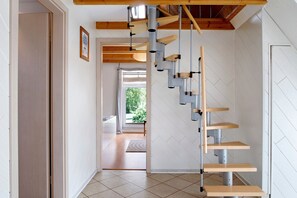 A modern staircase with a wooden finish and metal railings.