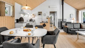 A modern interior with a dining area, kitchen, and living space. - "Rohan" - 700m from the sea by Interhome (Rødby)