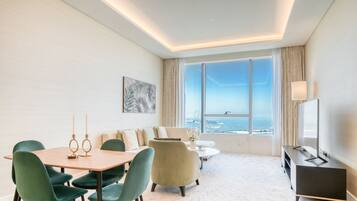 Deluxe Apartment, Sea View | Living area | 55-inch Smart TV with cable channels