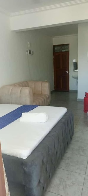Comfort Studio, City View | Living area | 24-inch Smart TV with digital channels - Lux Suites Vee Studio Apartments Bamburi (Mombasa)