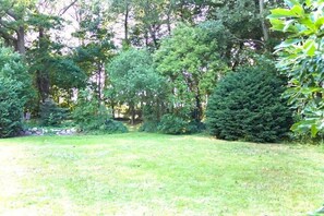Escape to a serene garden oasis, surrounded by lush greenery and open space.