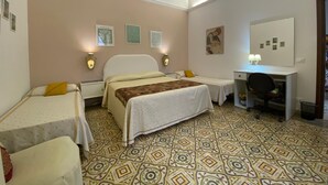 A hotel room with two single beds, a desk with a chair, and a large mirror. - The House of Flowers, in the heart of the Gulf of Macari 2.5 km from the sea. (Castelluzzo)