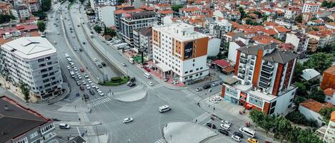 A multi-story hotel with a modern design, located at a busy intersection with a roundabout.