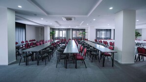 A conference room with long tables and chairs, large windows, and ceiling lights. - Marlen Hotel Denizli (Denizli)