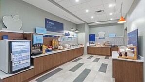 A modern breakfast area with a self-serve station, a refrigerator with yogurt, eggs, and milk, and a sign promoting a fresh breakfast experience. - Holiday Inn Express & Suites Senatobia I 55 by IHG (Senatobia)