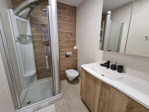 Shower, towels, soap, toilet paper