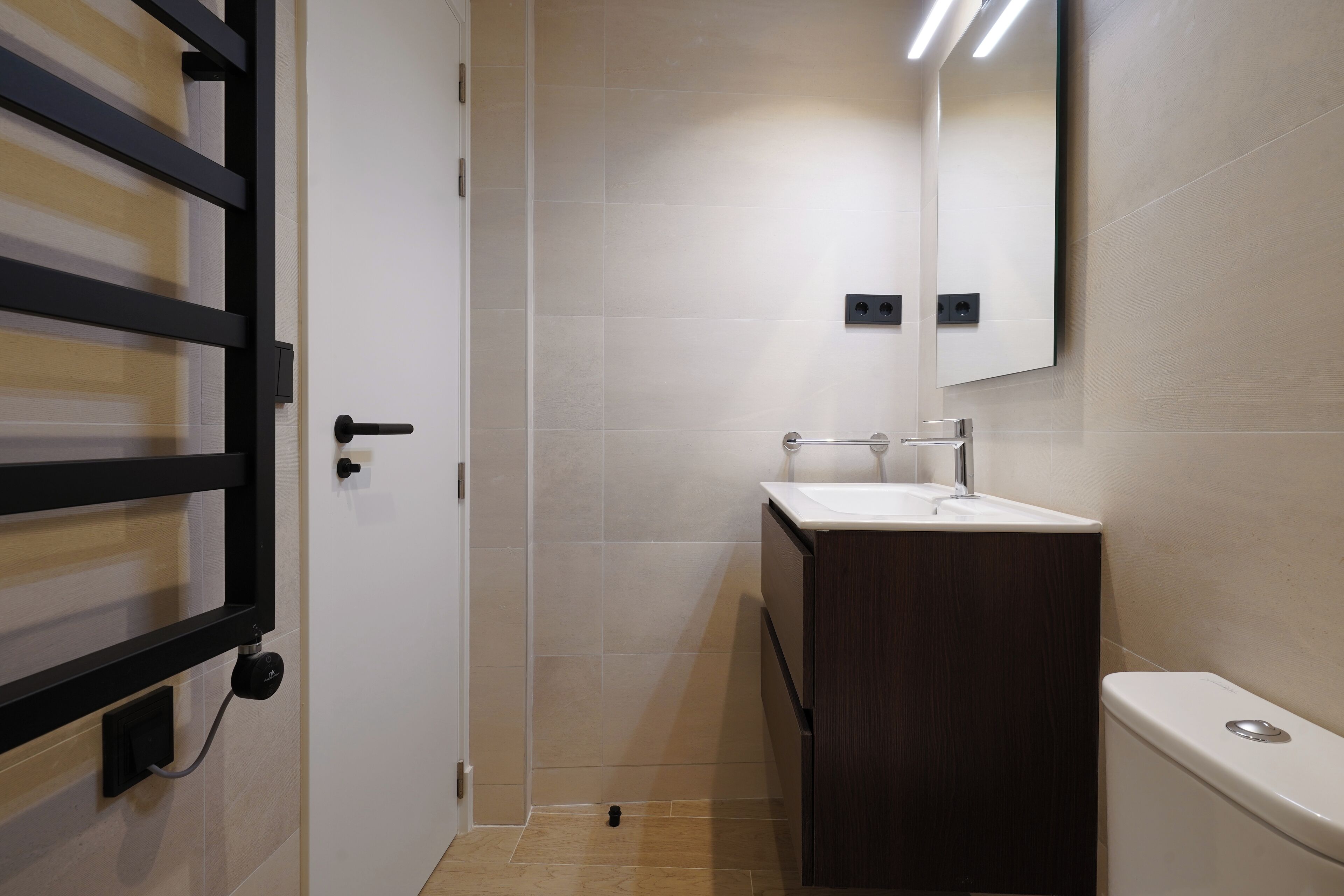 Ein modernes Badezimmer mit Dusche, Waschbecken und Toilette.