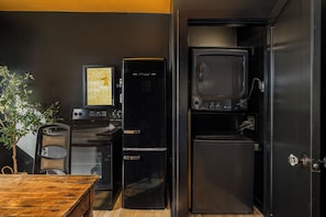 A compact kitchen with a refrigerator, oven, and microwave.