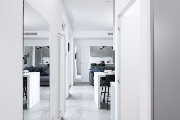 A modern, open-plan living space with a kitchen, dining area, and seating area.