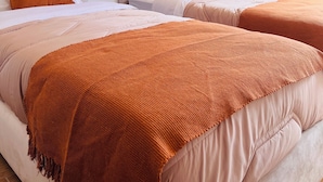 A hotel room with two beds, each with a headboard, a nightstand, and a small bedside table. - 2 Bedroom Apartment in Marrakech (Marrakech)