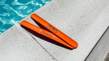 Two orange floating devices labeled "The Villas" by "A. Munch & Co" by a pool.