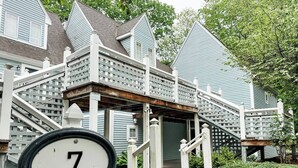 A house with a white number 7 sign in front.