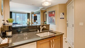 A modern kitchen with a large island, built-in appliances, and a view to the living area. - SVS: Designer Remodeled 1BD | Strip View Balcony | Signature at MGM (Las Vegas)