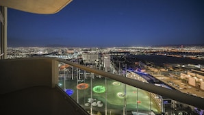 A night view from a high-rise balcony overlooking a cityscape with illuminated streets and buildings. - 1BD/2BA • Balcony • No Resort Fee • Free Parking E24I2 (Las Vegas)