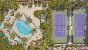 An aerial view of a resort with a large swimming pool, tennis courts, and landscaped areas. - SVS: Bright 1BD Condo | Gated Community | Pool | Near the Strip (Las Vegas)