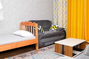 Family Apartment, City View | Living area | 24-inch Smart TV with digital channels - Lux Suites Bamburi Furnished Apartments (Mombasa)