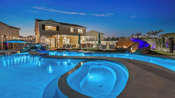 A swimming pool with a hot tub, lounge chairs, and umbrellas. - Electric Slide- Lazy River, Pickleball, Resort backyard & Game room (coachella)