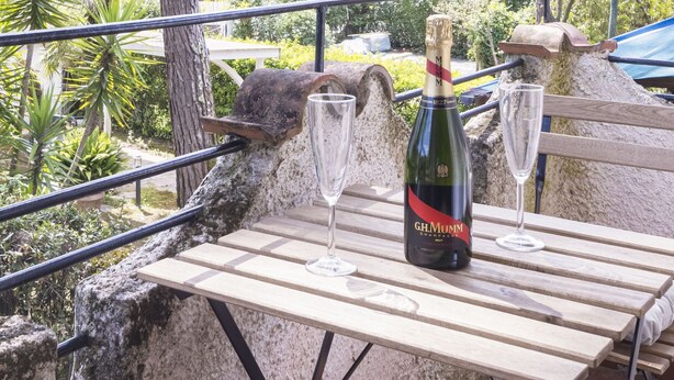 A wooden table with a bottle of champagne and two glasses on it. - Wonderful  villa for 5 people with WIFI, A/C, TV, terrace and pets allowed, close to Forte Dei M... (Marina Dei Ronchi)