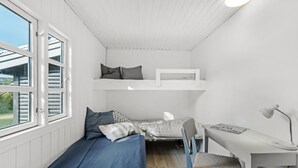 A compact room with a bunk bed, a desk with a chair, and a window. - "Synnöve" - 350m from the sea by Interhome (Væggerløse)