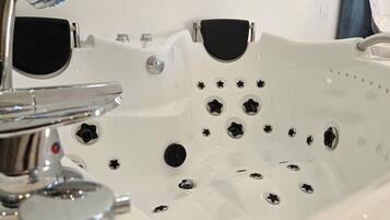 Jetted tub, hair dryer, towels, soap