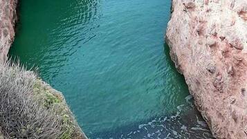 A natural rock formation with a water channel.