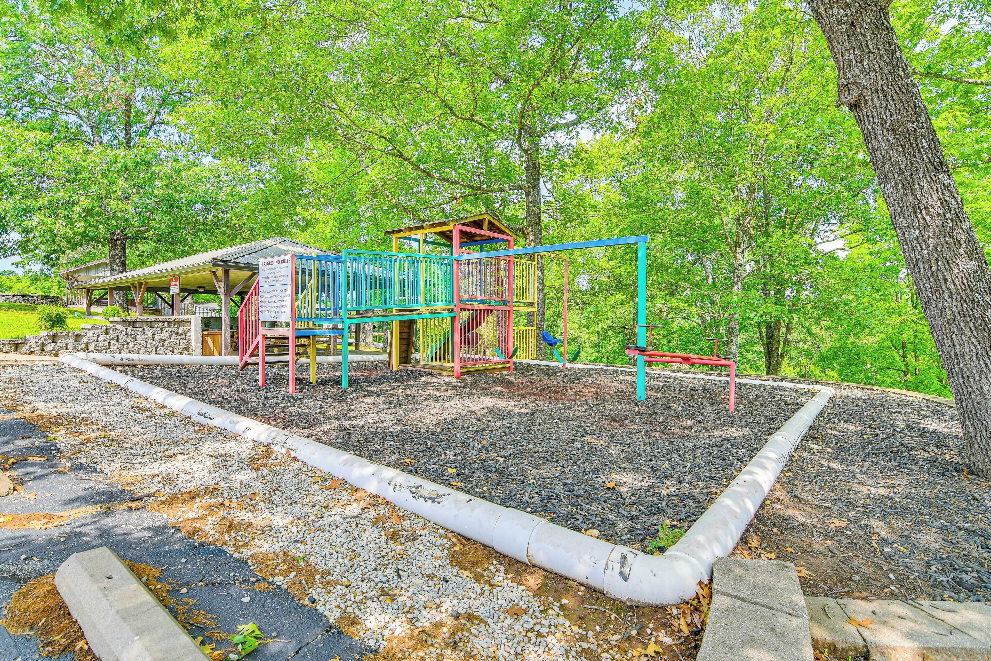 A playground with a climbing structure and a covered seating area.
