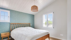 A bedroom with a wooden bed, a wicker hanging light, and patterned wallpaper. - New house- 6 adults & 4 children - 350m beach (Noirmoutier-en-l´Ile)
