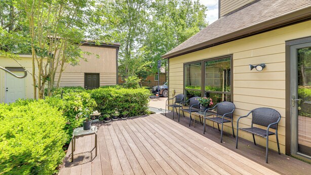 A wooden deck with outdoor seating and a glass door entrance. - Morehead City Home ~ Walk to Beach Park! (Morehead City)