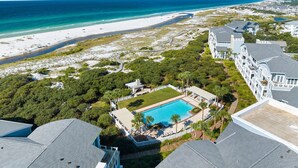 A resort with a swimming pool, beachfront view, and multiple buildings. - Retreat Steps from Sugar-White Sand (Watersound)