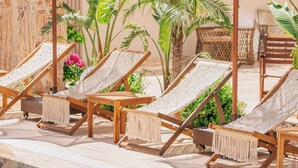 A poolside area with lounge chairs and umbrellas. - Los Suites (Konyaalti)