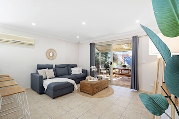 Step into this bright and inviting open-plan living space, bathed in natural light and featuring gleaming timber floors.