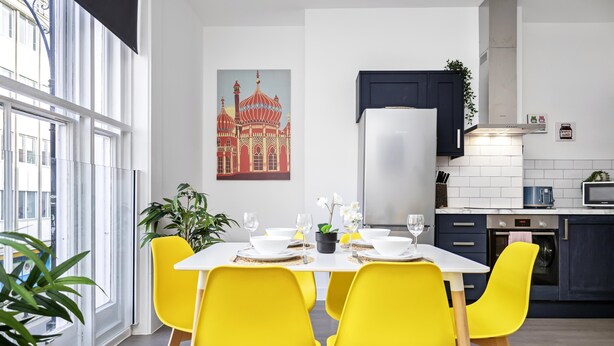 A modern kitchen with white cabinets, a stainless steel refrigerator, and a microwave. - Queens Mile 1 With Free Parking By My Getaways (Brighton)