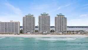 A beachfront hotel with multiple high-rise buildings, a sandy beach, and the ocean. - Slow M'Ocean - Summerwind 1302C (Navarre)