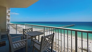 A balcony with a view of a beach and pier. - Knot a Care- Summerwind 1102C (Navarre)