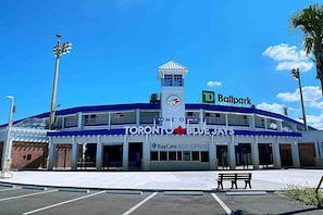 A stadium with a blue and white exterior, a tower, and a TD Ballpark sign.