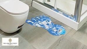 A modern bathroom with a glass-enclosed shower, a white toilet, and a patterned rug on the floor. - Villa Rio Boutique Hotel (Atimpoku)
