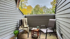 A covered outdoor seating area with a view of autumn trees. - Bearities - 2 homes, sleeps 28, hot tubs, grills! (Killington)