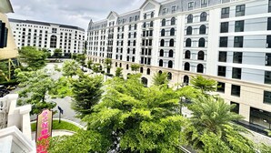 Un hotel de varios pisos con un patio central rodeado de vegetación exuberante y arquitectura moderna.