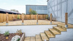 A paved patio with stone steps leading to a wooden fence. - 2 bedroom accommodation in Ayr (Ayr)